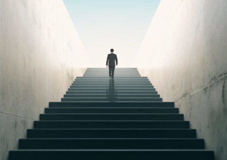 Ambitions concept with businessman climbing stairs