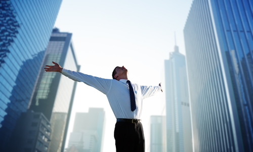 happy young businessman and big city